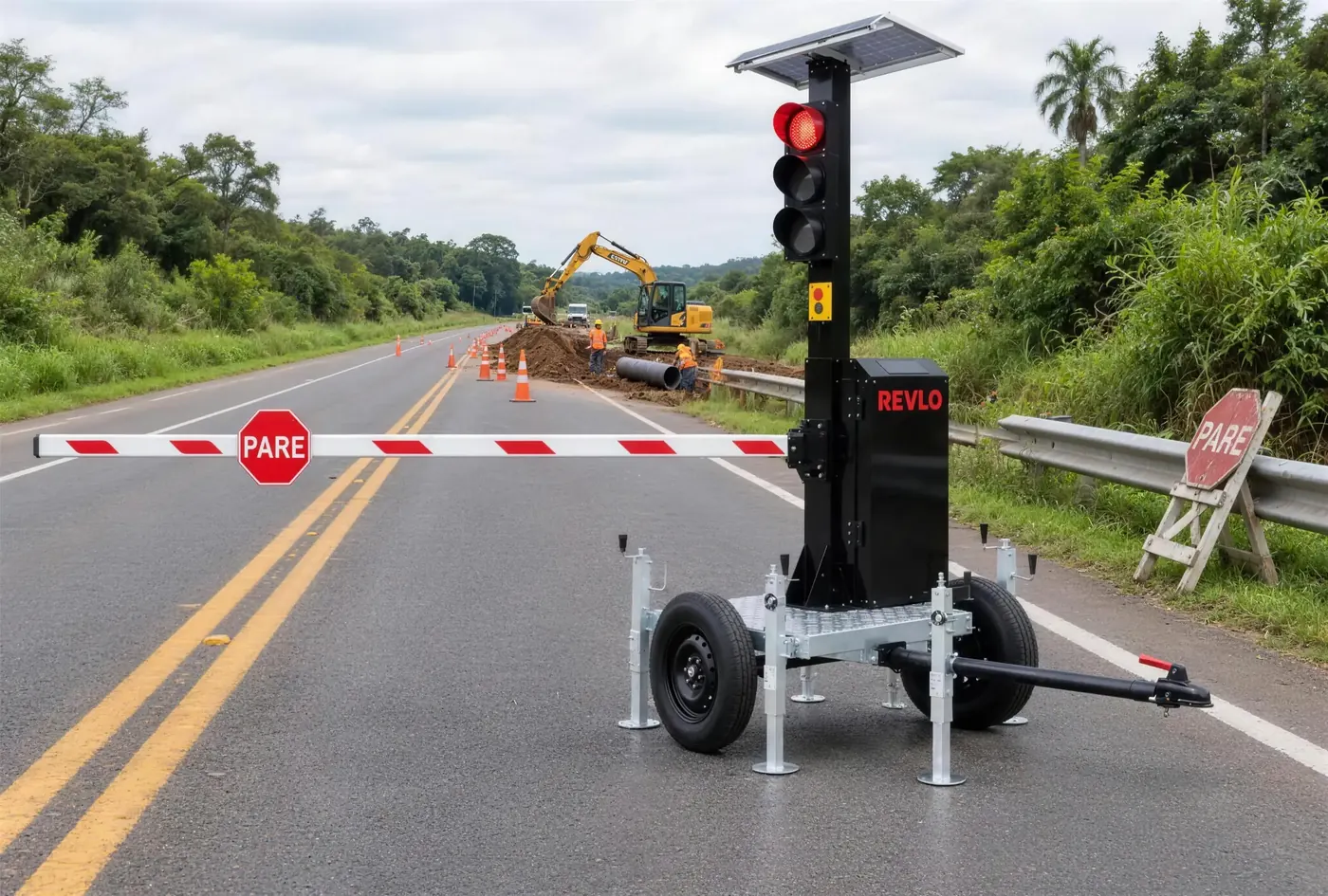 Semáforo móvel com cancela em obra de rodovia com equipamento de terraplenagem ao fundo